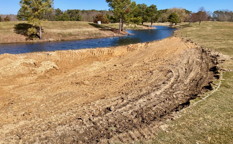 The pond behind the 15th green will eventually flood into a sloped area behind a small pile of dirt piled up against it, once the contractors finish shaping the disturbed area just right of the 13th green at The Rookery. The larger water hazard will make long hitters think a bit more about trying to reach the par-5 green in two shots. FRITZ SCHRANCK PHOTOS